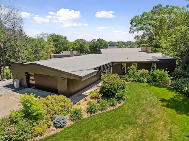 5962 Hobe Ln, White Bear Twp, MN 55110 - view of front of house with a garage, a front lawn, and a chimney