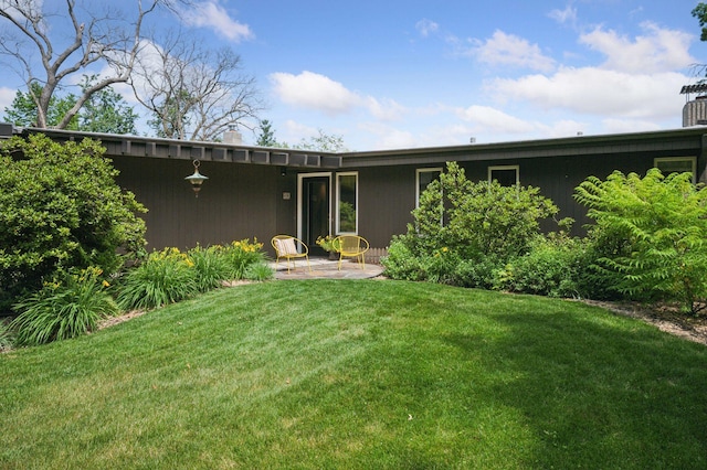 5962 Hobe Ln, White Bear Twp, MN 55110 - rear view of house featuring a lawn, a patio area, and a chimney