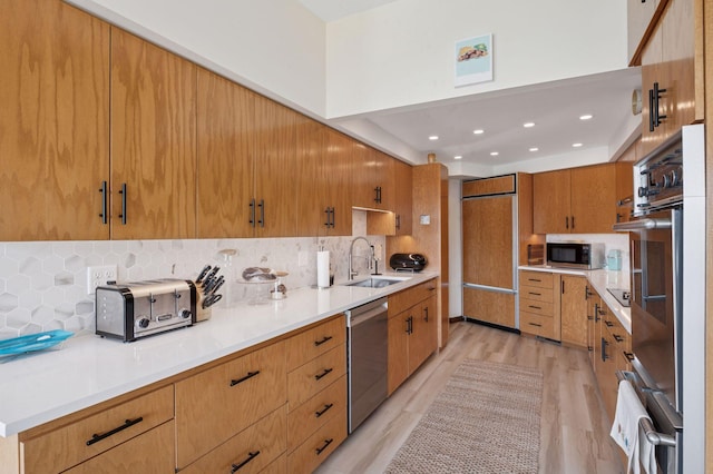 5962 Hobe Ln, White Bear Twp, MN 55110 - kitchen featuring appliances with stainless steel finishes, light wood finished floors, tasteful backsplash, light countertops, and recessed lighting
