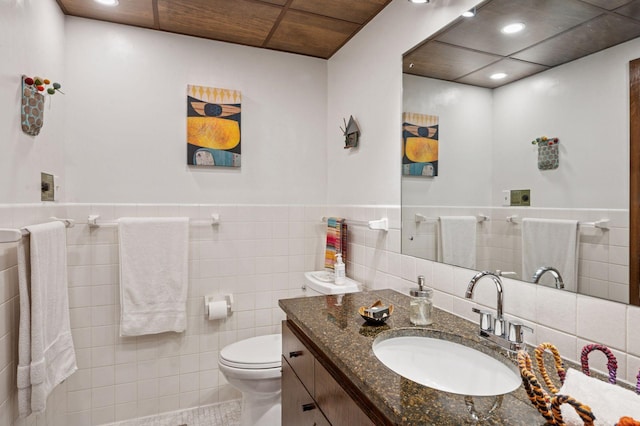 5962 Hobe Ln, White Bear Twp, MN 55110 - bathroom featuring tile walls, vanity, recessed lighting, and a wainscoted wall