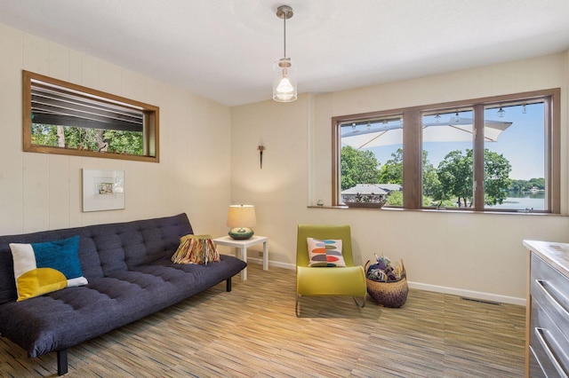 5962 Hobe Ln, White Bear Twp, MN 55110 - living room featuring light wood-style floors and wooden walls