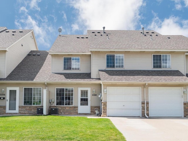 2248 Affirmed Dr, Shakopee, MN 55379 - view of front of house featuring stone siding, driveway, a front lawn, a garage, and a shingled roof