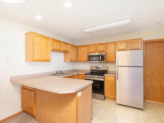 2248 Affirmed Dr, Shakopee, MN 55379 - kitchen featuring stainless steel appliances, a peninsula, light countertops, recessed lighting, and light flooring