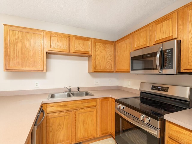 2248 Affirmed Dr, Shakopee, MN 55379 - kitchen with appliances with stainless steel finishes, light countertops, and a textured ceiling