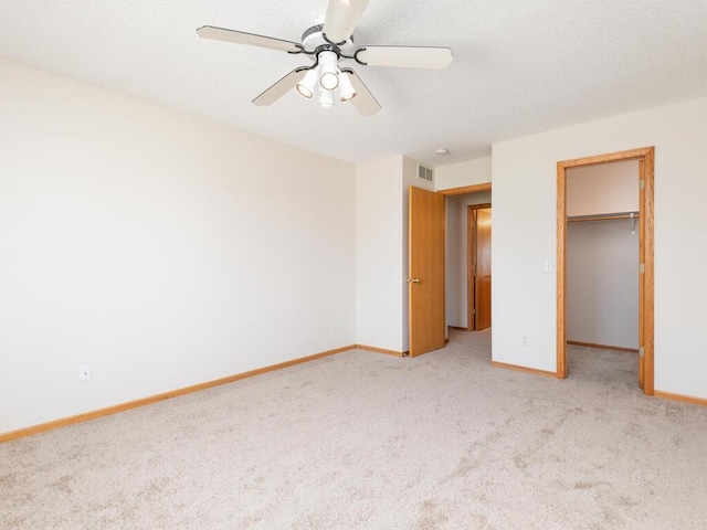 2248 Affirmed Dr, Shakopee, MN 55379 - unfurnished bedroom with light carpet, a walk in closet, ceiling fan, and a closet