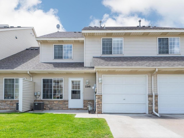2248 Affirmed Dr, Shakopee, MN 55379 - view of property featuring stone siding, a garage, driveway, and a shingled roof