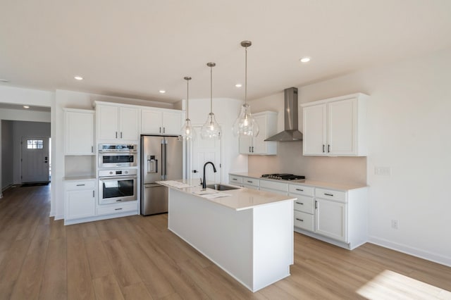 9755 49th St NE, Saint Michael, MN 55376 - kitchen with stainless steel appliances, wall chimney range hood, light wood-style floors, light countertops, and recessed lighting