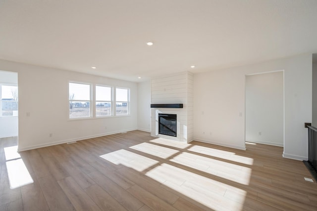 9755 49th St NE, Saint Michael, MN 55376 - unfurnished living room with light wood finished floors, recessed lighting, and a fireplace