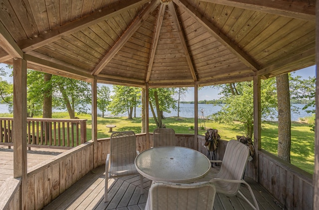 551 Edward Ln NE, Longville, MN 56655 - wooden terrace featuring a water view, a lawn, outdoor dining space, and a gazebo