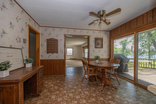 551 Edward Ln NE, Longville, MN 56655 - dining area with wallpapered walls, wainscoting, a ceiling fan, wooden walls, and ornamental molding