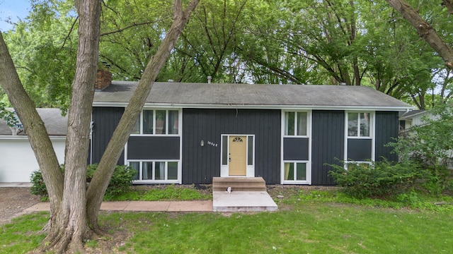 10048 Upton Rd, Bloomington, MN 55431 - view of front of home with a chimney and a front yard