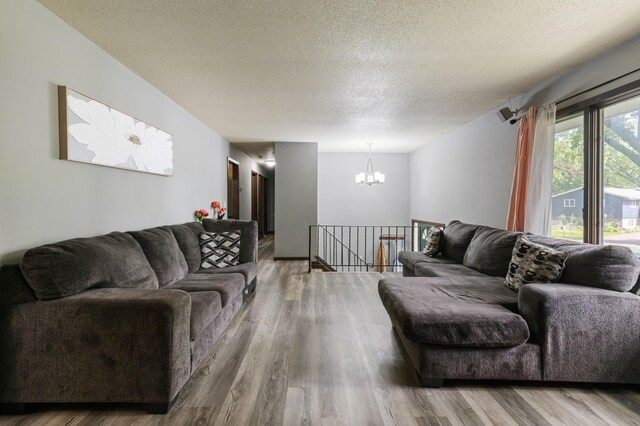10048 Upton Rd, Bloomington, MN 55431 - living room with a chandelier, a textured ceiling, and wood finished floors