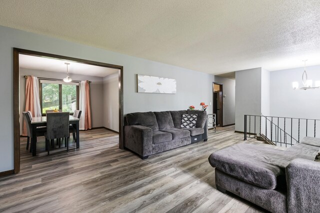 10048 Upton Rd, Bloomington, MN 55431 - living area with a chandelier, wood finished floors, and a textured ceiling
