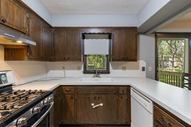 10048 Upton Rd, Bloomington, MN 55431 - kitchen with stainless steel range with gas cooktop, white dishwasher, exhaust hood, light countertops, and dark brown cabinetry