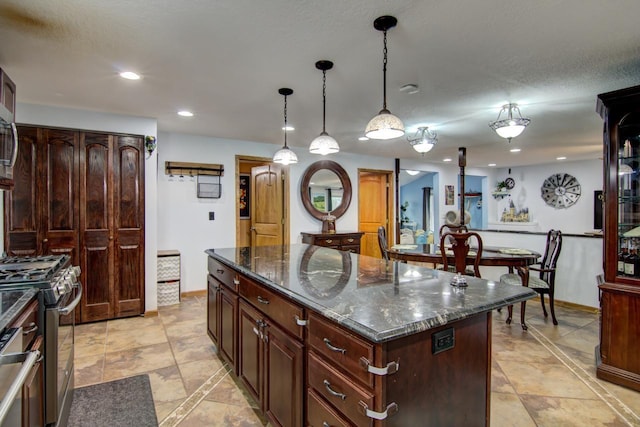 427 Alleghany Ave, Wabasha, MN 55981 - kitchen featuring stainless steel range with gas cooktop, a center island, recessed lighting, hanging light fixtures, and dark stone countertops