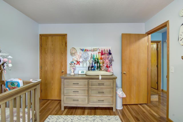 427 Alleghany Ave, Wabasha, MN 55981 - bedroom featuring dark wood-style floors and a nursery area