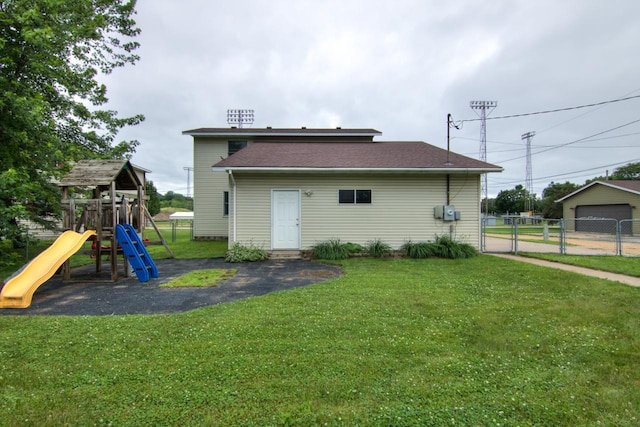427 Alleghany Ave, Wabasha, MN 55981 - rear view of property with a playground, a gate, and a detached garage