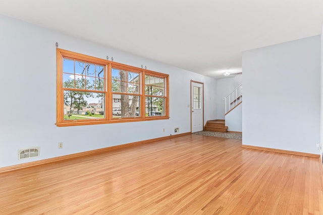 1920 108th Ln NW, Coon Rapids, MN 55433 - unfurnished room with light wood-style floors and stairs