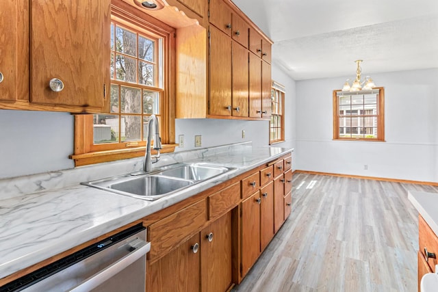 1920 108th Ln NW, Coon Rapids, MN 55433 - kitchen featuring stainless steel dishwasher, light countertops, healthy amount of natural light, and light wood-style flooring