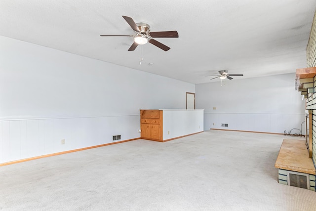 1920 108th Ln NW, Coon Rapids, MN 55433 - unfurnished living room featuring ceiling fan, light colored carpet, a brick fireplace, and wainscoting