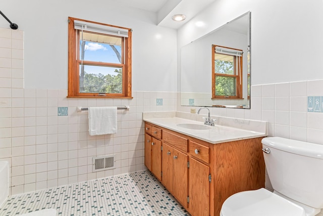1920 108th Ln NW, Coon Rapids, MN 55433 - full bath featuring tile walls, vanity, healthy amount of natural light, and wainscoting