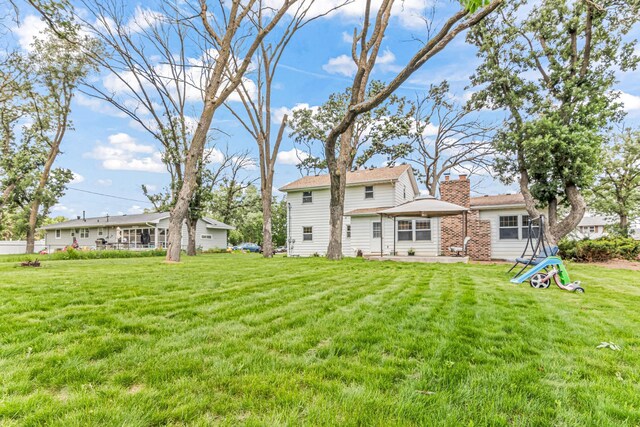 1920 108th Ln NW, Coon Rapids, MN 55433 - rear view of property featuring a yard and a chimney