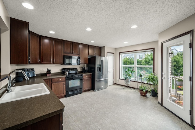 5062 French Dr N, Hugo, MN 55038 - kitchen featuring black appliances, dark countertops, recessed lighting, dark brown cabinetry, and a textured ceiling