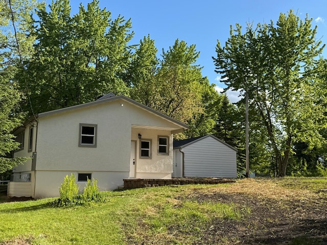 6821 225th Ln N, Stacy, MN 55079 - back of house with stucco siding and a lawn