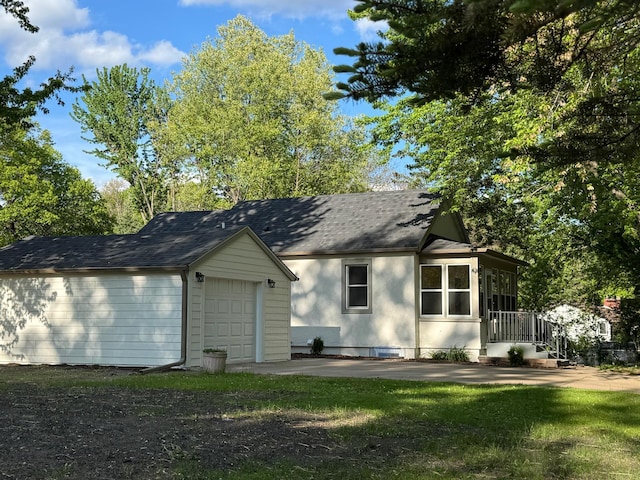 6821 225th Ln N, Stacy, MN 55079 - rear view of house with an outdoor structure, a shingled roof, and a garage