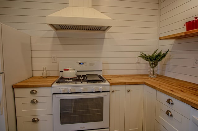 850 60th Ave SW, Benson, MN 56231 - kitchen featuring wooden counters, gas range gas stove, custom range hood, wood walls, and white cabinets