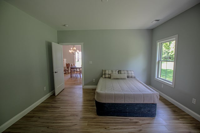 850 60th Ave SW, Benson, MN 56231 - bedroom featuring a chandelier and dark wood-type flooring