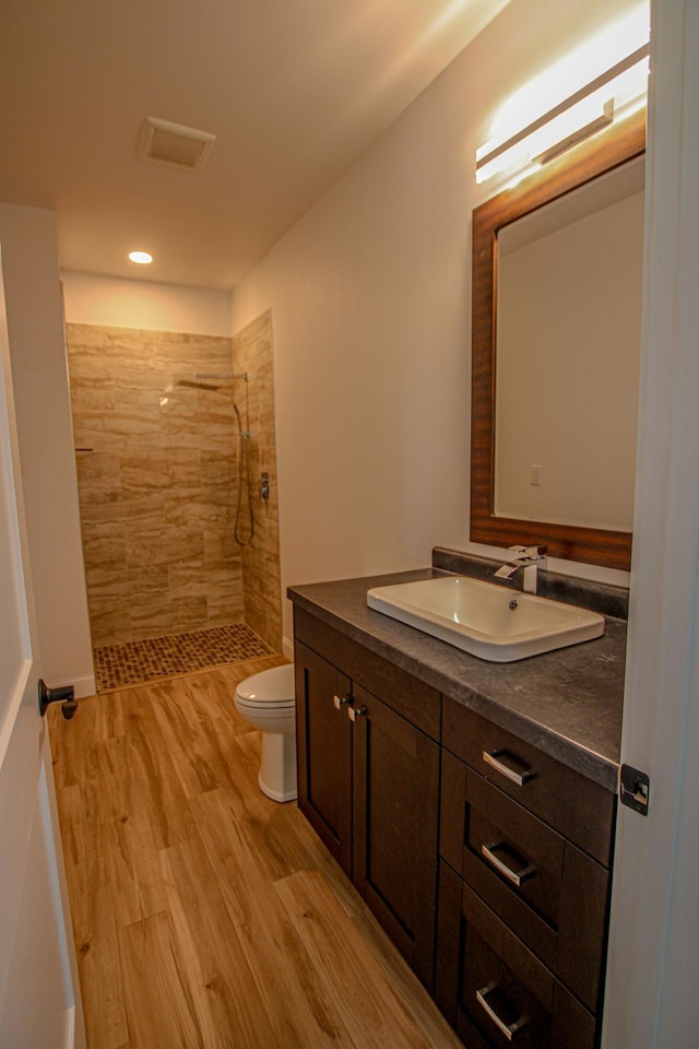 850 60th Ave SW, Benson, MN 56231 - full bathroom with vanity, tiled shower, wood finished floors, and recessed lighting