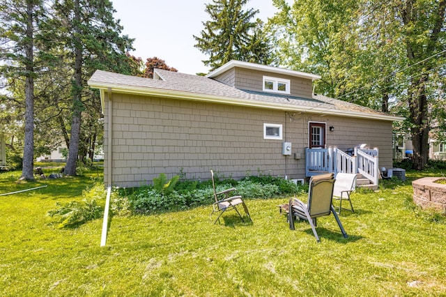 4223 Mcculloch St, Duluth, MN 55804 - back of property with a shingled roof, a lawn, and a chimney