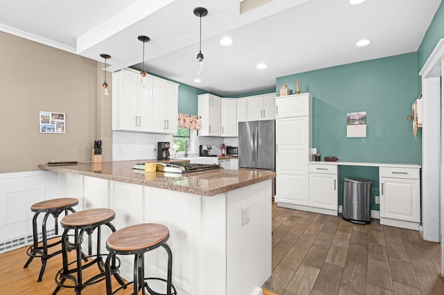 4223 Mcculloch St, Duluth, MN 55804 - kitchen featuring a peninsula, white cabinets, recessed lighting, freestanding refrigerator, and stone counters