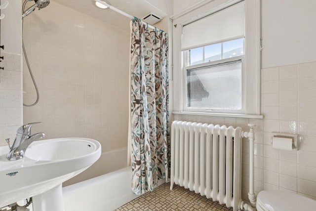 2085 Princeton Ave, Saint Paul, MN 55105 - bathroom featuring radiator, shower / bathtub combination with curtain, and tile walls