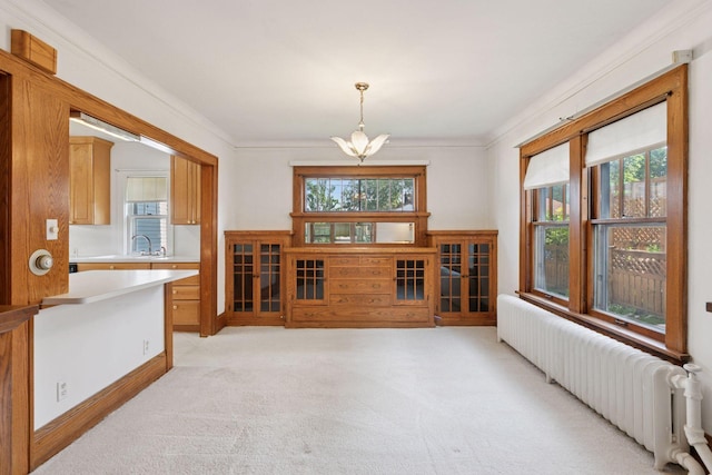 2085 Princeton Ave, Saint Paul, MN 55105 - dining room with radiator, a chandelier, plenty of natural light, light colored carpet, and crown molding