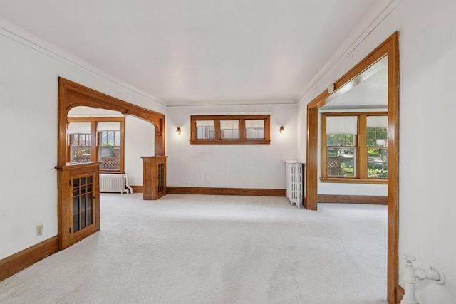 2085 Princeton Ave, Saint Paul, MN 55105 - unfurnished living room with radiator heating unit, carpet, and ornamental molding