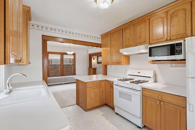 2085 Princeton Ave, Saint Paul, MN 55105 - kitchen with white range with gas cooktop, radiator heating unit, under cabinet range hood, a peninsula, and light countertops