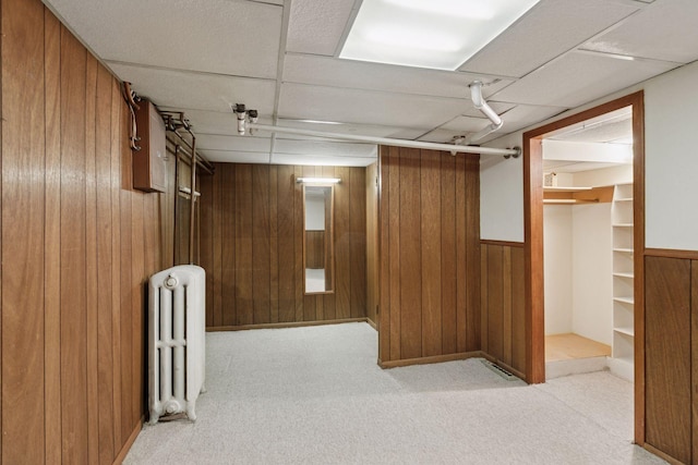 2085 Princeton Ave, Saint Paul, MN 55105 - finished basement featuring radiator heating unit, wooden walls, carpet flooring, and a drop ceiling
