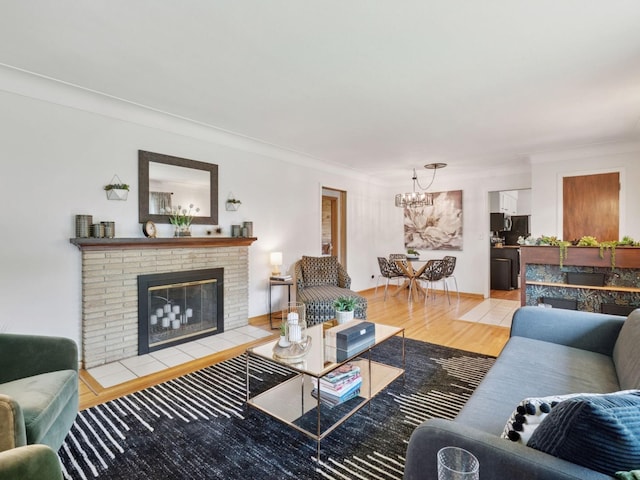 910 62nd St, Minneapolis, MN 55419 - living room with a chandelier, light wood finished floors, a brick fireplace, and crown molding