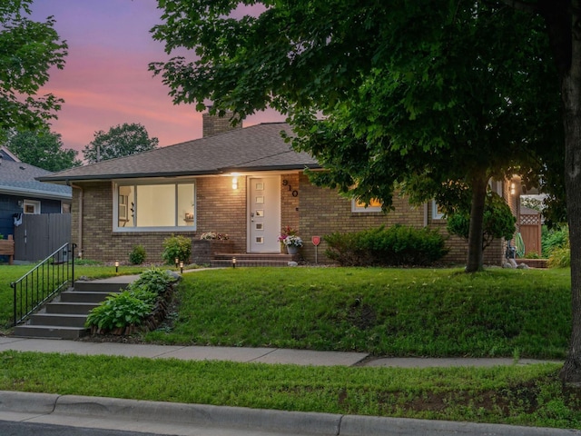 910 62nd St, Minneapolis, MN 55419 - view of front of house featuring brick siding, a front lawn, and a chimney