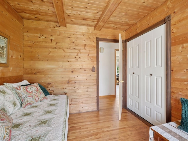 910 62nd St, Minneapolis, MN 55419 - bedroom featuring a wooden ceiling with exposed beams, wood walls, light wood-style floors, and a closet