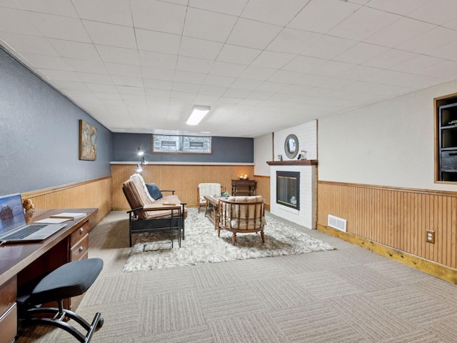 910 62nd St, Minneapolis, MN 55419 - living area featuring wainscoting, a brick fireplace, carpet flooring, an office area, and wood walls