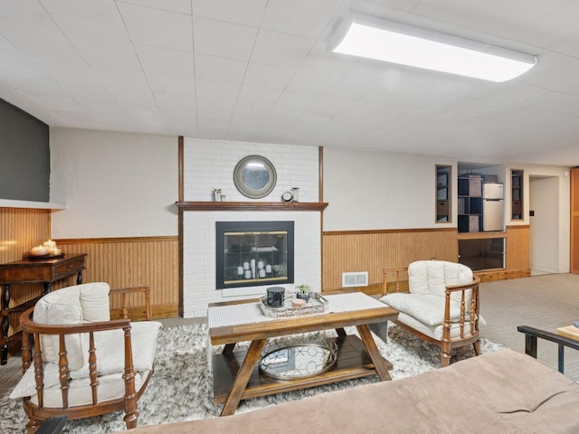 910 62nd St, Minneapolis, MN 55419 - living room with wainscoting, a brick fireplace, and wooden walls