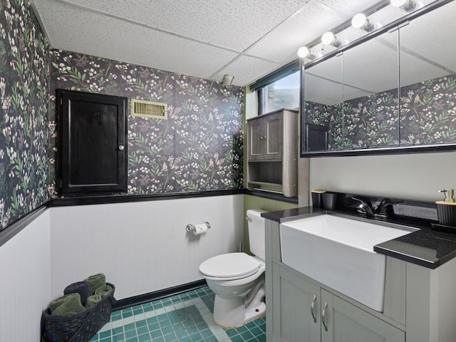 910 62nd St, Minneapolis, MN 55419 - bathroom featuring wallpapered walls, vanity, and a wainscoted wall