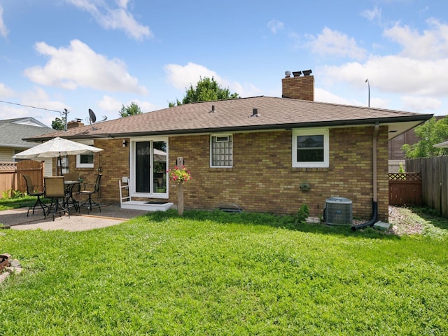 910 62nd St, Minneapolis, MN 55419 - rear view of property with a fenced backyard, a chimney, a patio area, brick siding, and a shingled roof