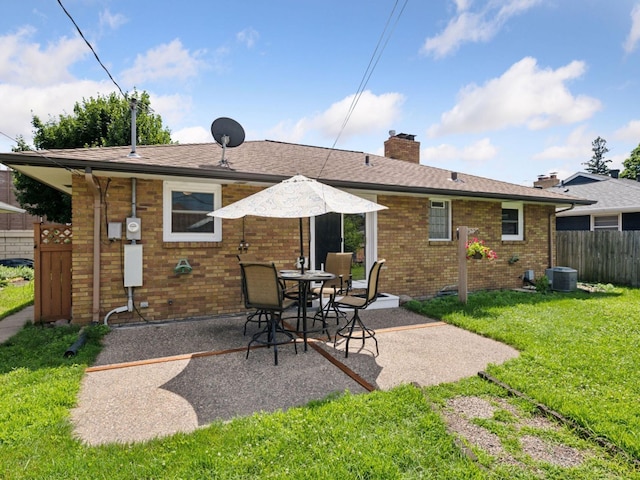 910 62nd St, Minneapolis, MN 55419 - back of property with a patio, brick siding, and a chimney