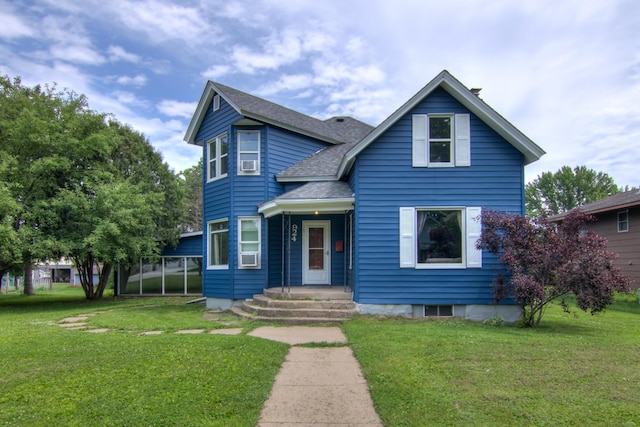 924 6th St W, Wabasha, MN 55981 - view of front facade with a shingled roof, a front lawn, and cooling unit