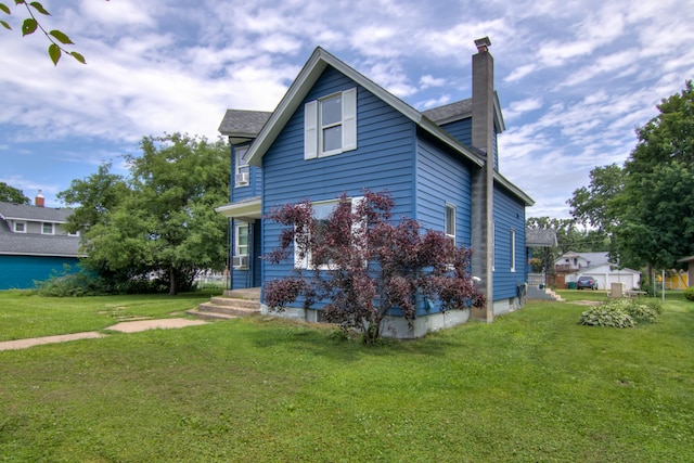924 6th St W, Wabasha, MN 55981 - view of side of home with a chimney and a yard