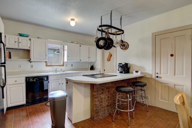 924 6th St W, Wabasha, MN 55981 - kitchen with black appliances, white cabinetry, a peninsula, and a textured ceiling